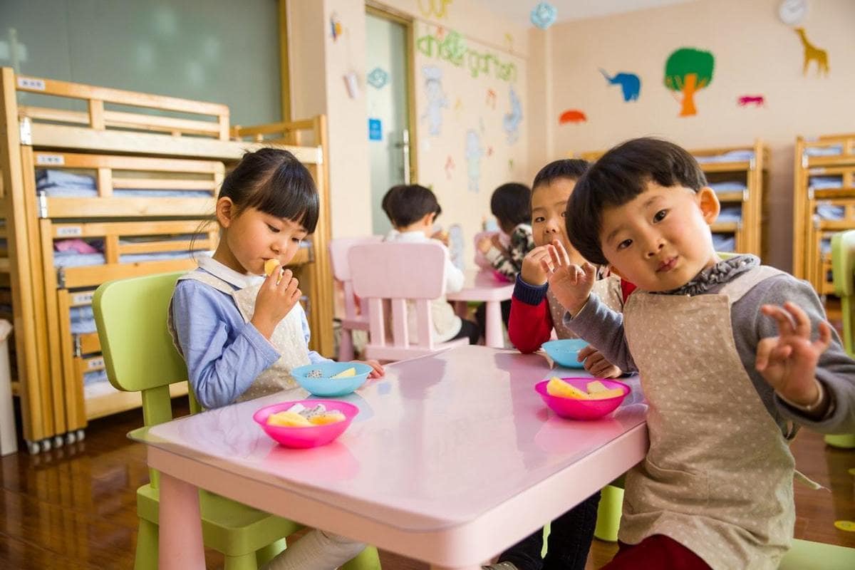 Three Toddler Eating On White Table 1001914